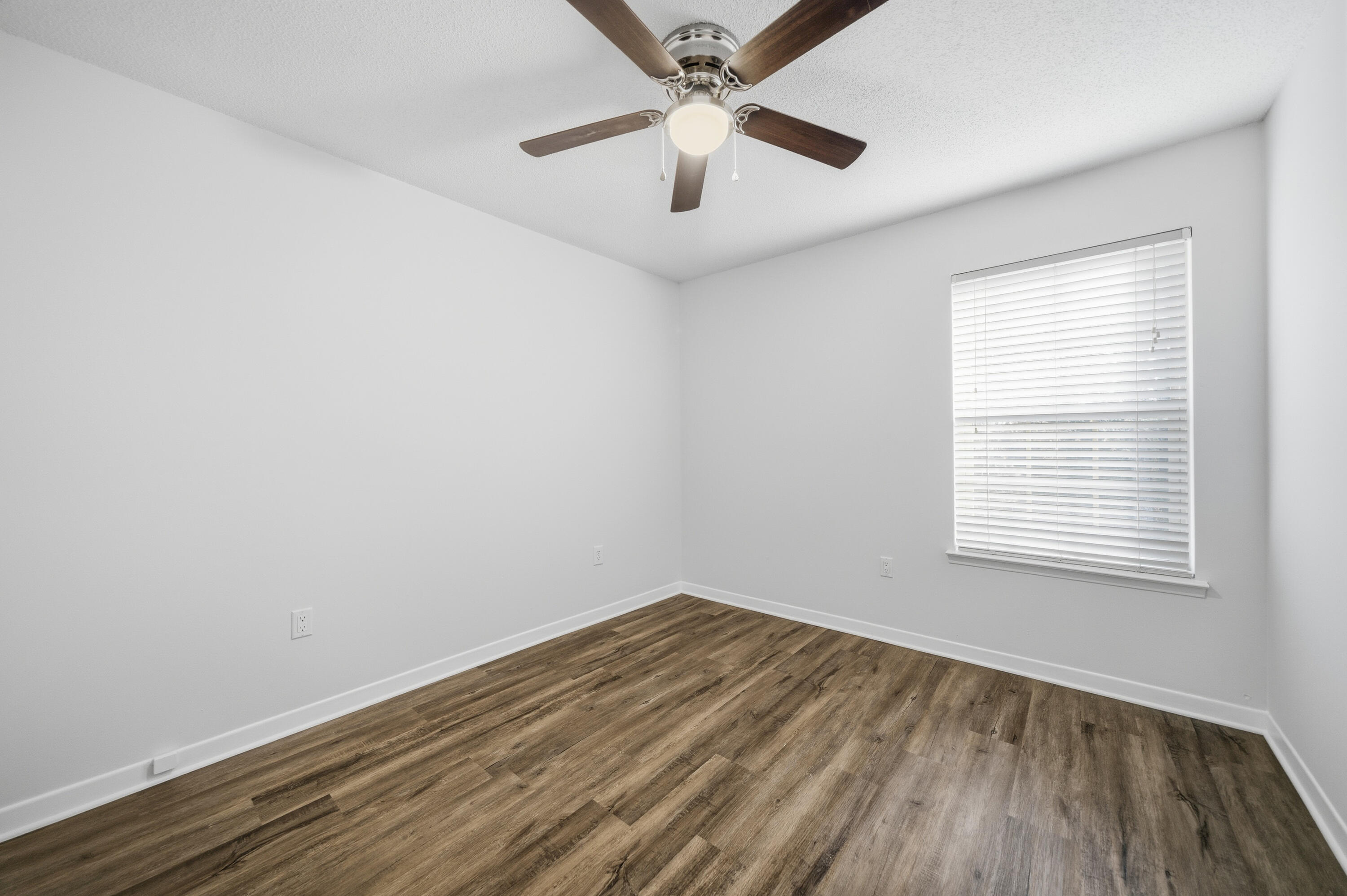 411 Ashley Drive Crestview, FL 32536 - Photo 26 of 44 an empty room with a window and a ceiling fan