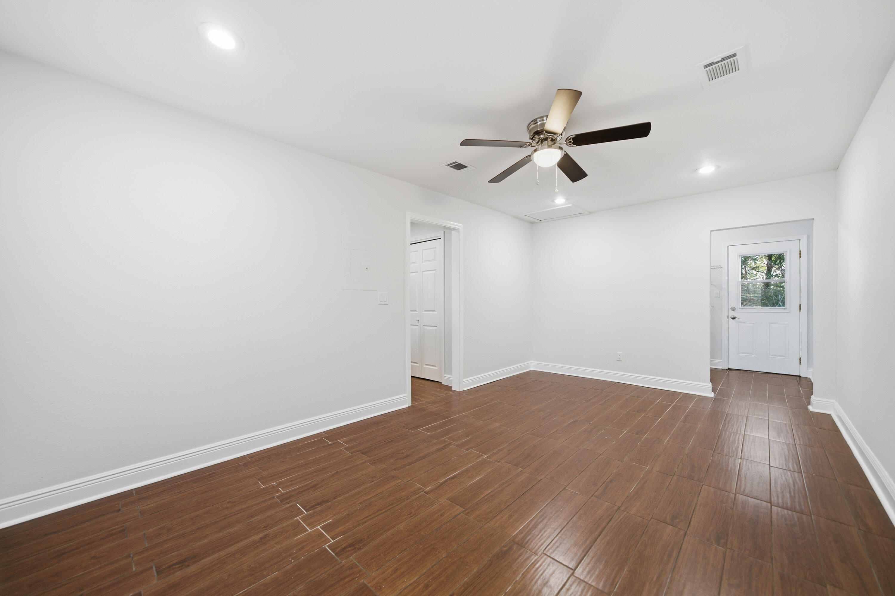 411 Ashley Drive Crestview, FL 32536 - Photo 29 of 44 an empty room with wooden floor and windows