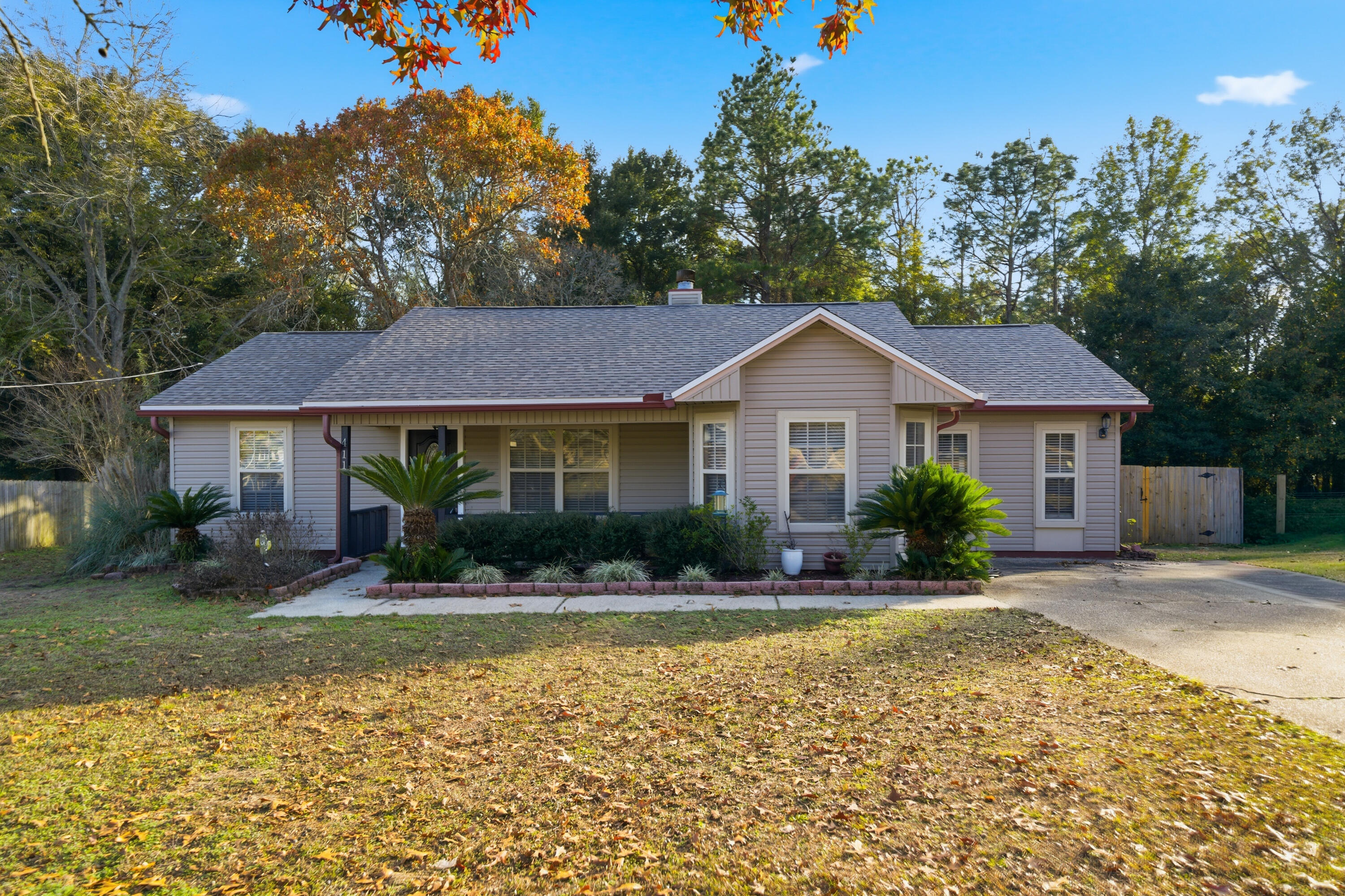 411 Ashley Drive Crestview, FL 32536 - Photo 3 of 44 a front view of a house with a yard