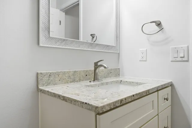 a bathroom with a sink and a mirror