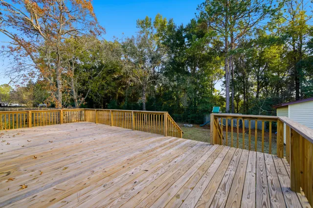 a view of backyard with deck and trees