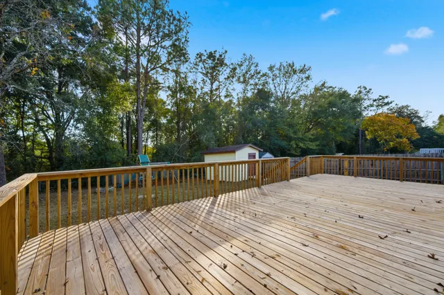 a view of balcony with wooden floor and fence