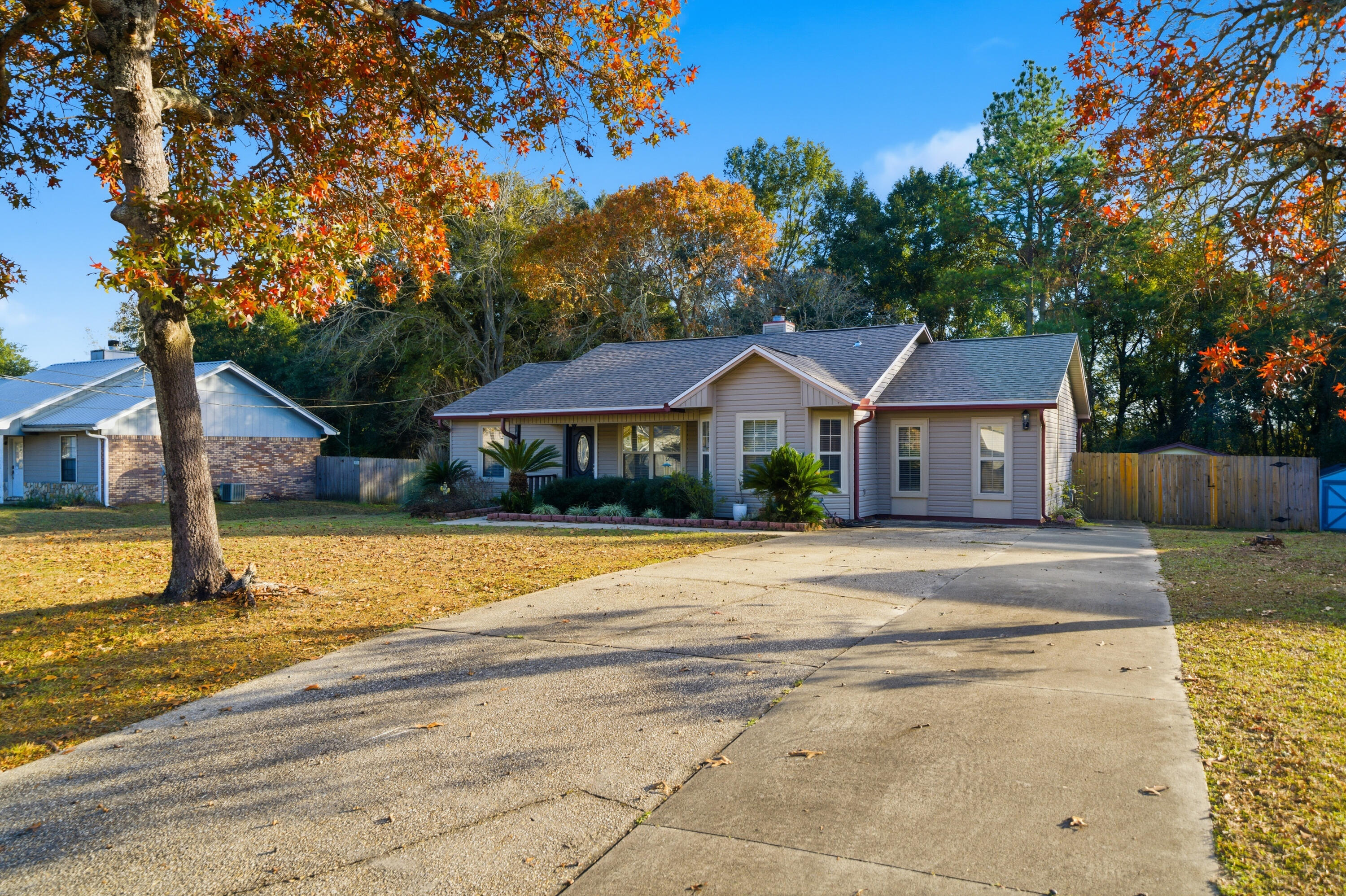 411 Ashley Drive Crestview, FL 32536 - Photo 5 of 44 a front view of a house with a yard