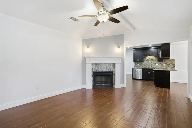 a view of kitchen and living room with wooden floor