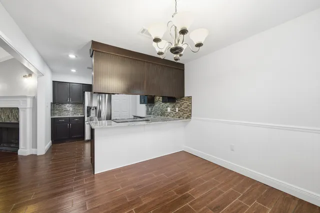 a view of kitchen with sink and wooden floor