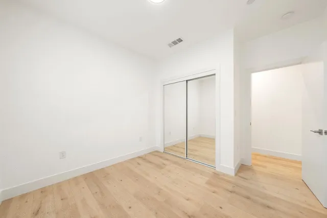 a view of a room with wooden floor