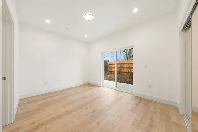 an empty room with closet and windows