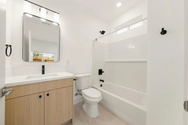 a view of backyard and wooden fence