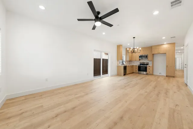 a view of a kitchen with a sink and a refrigerator