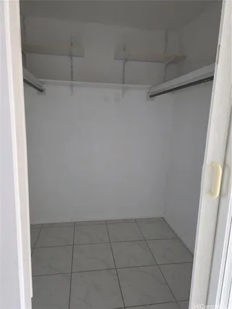 an empty room with a ceiling fan and window