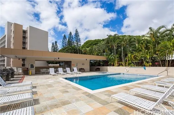 a view of a swimming pool with a lounge chairs