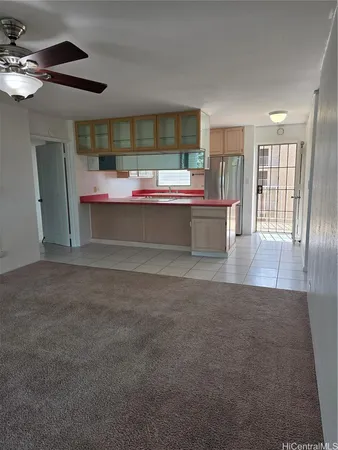 a living room with furniture and a kitchen