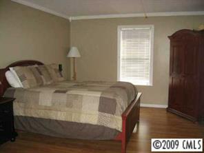 9734 Fairway Ridge Road Charlotte, NC 28277 - Photo 4 of 7 a bedroom with a bed and wooden floor
