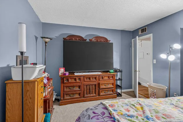 a view of a hallway with wooden floor and furniture