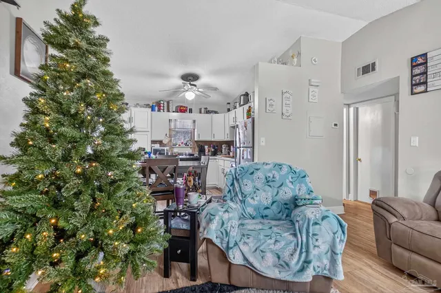 a backyard of a house with yard and wooden chairs