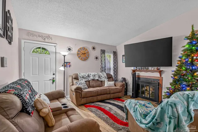 a living room with furniture and a flat screen tv
