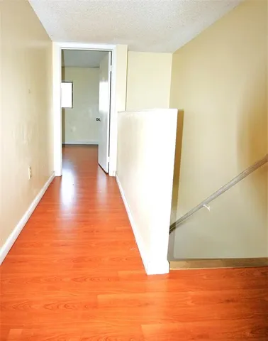 a view of a room with wooden floor