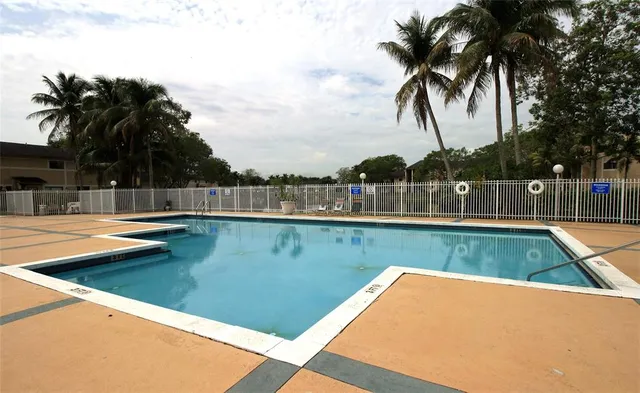 a view of a backyard with a swimming pool