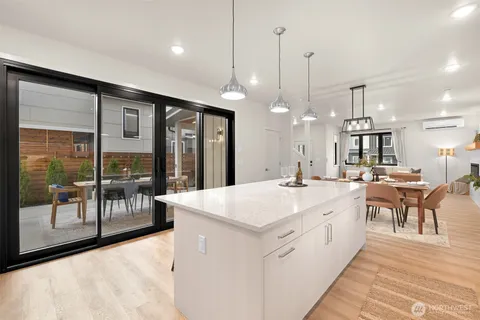 a large kitchen with kitchen island a island a sink a stove and a large window