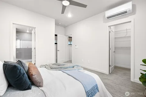 a bedroom with a bed and a mirror