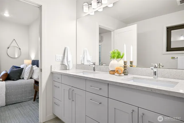a en suite bathroom with a double vanity sink and a mirror
