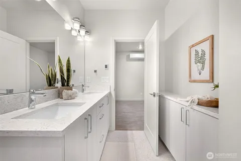 a bathroom with a double vanity sink and a mirror