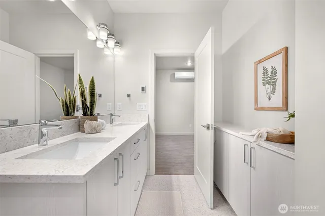 a bathroom with a double vanity sink and a mirror