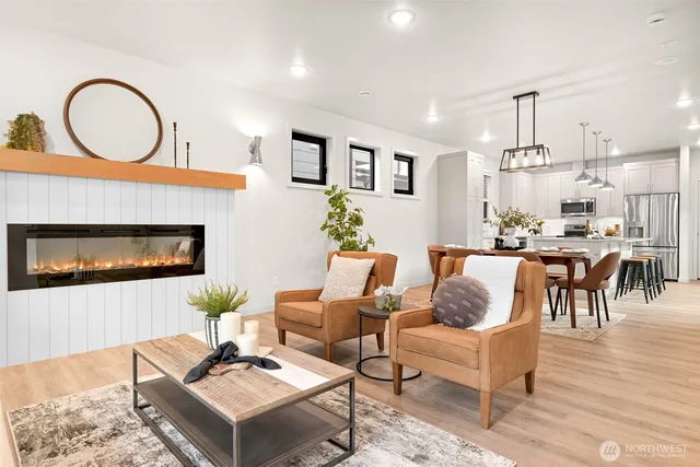 a living room with furniture a dining table and kitchen view