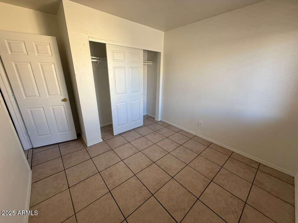 712 East 17th Street, Unit B Douglas, AZ 85607 - Photo 12 of 20 an empty room with wooden floor
