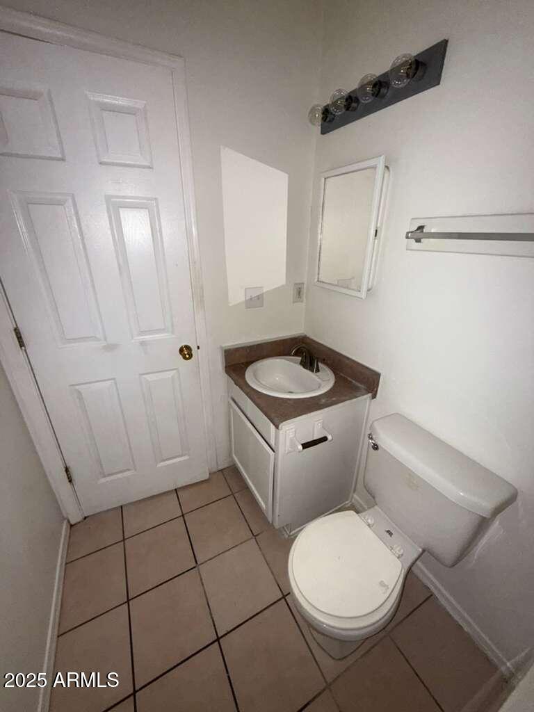712 East 17th Street, Unit B Douglas, AZ 85607 - Photo 14 of 20 a white toilet sitting next to a bathroom sink and vanity