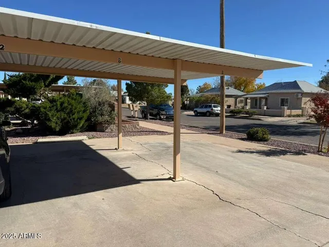 a patio with a table and chairs under an umbrella