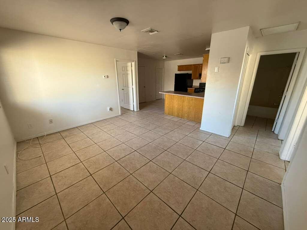 712 East 17th Street, Unit B Douglas, AZ 85607 - Photo 2 of 20 a view of a refrigerator in kitchen and wooden floor