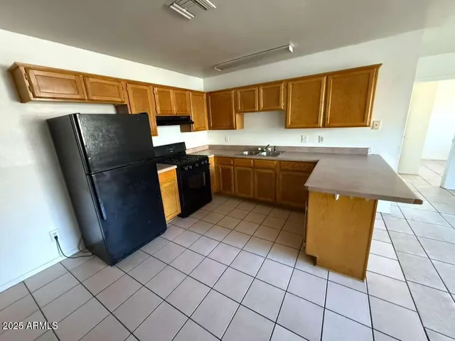 a kitchen with stainless steel appliances granite countertop a refrigerator and a stove