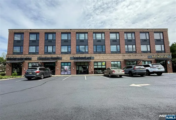 a view of building with cars