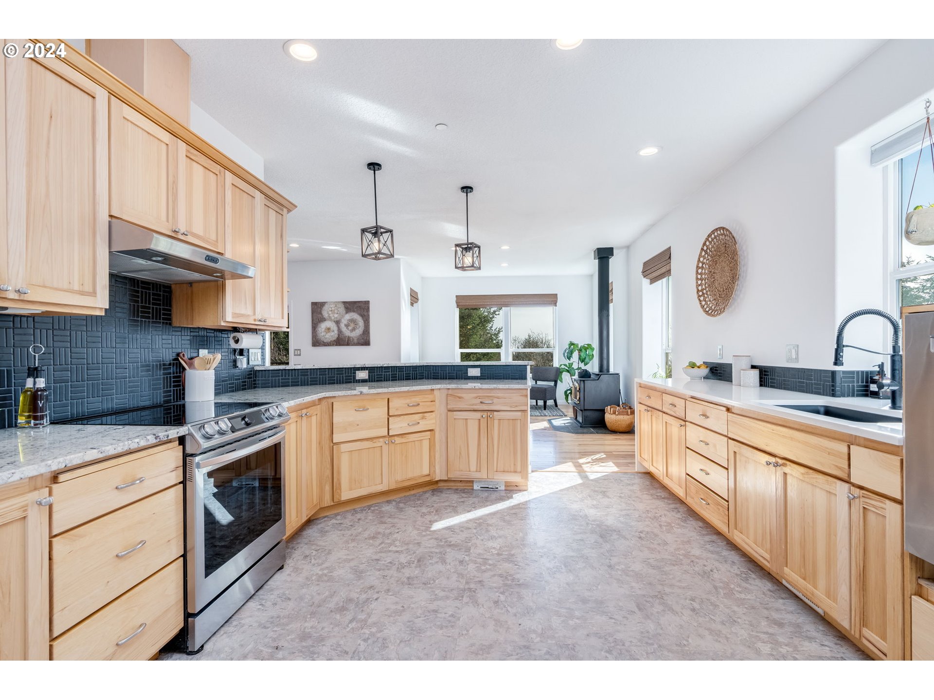5605 Northeast Lessard Road Camas, WA 98607 - Photo 19 of 47 a large kitchen with stainless steel appliances granite countertop a stove sink and cabinets