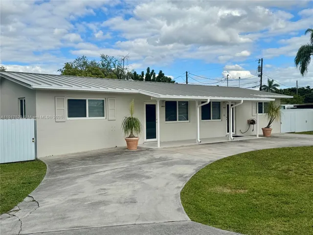 a view of a house with roof deck front of house