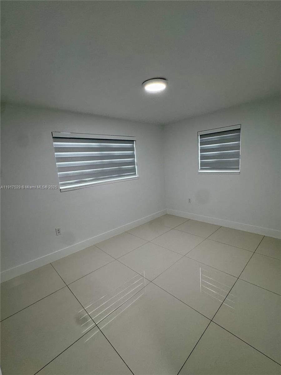 8101 Southwest 4th Street, Unit 8101 Miami, FL 33144 - Photo 8 of 14 a view of an empty room with a window