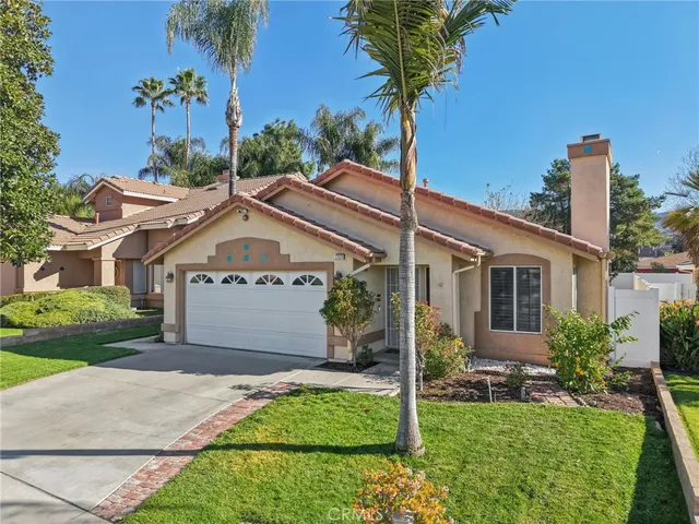 an aerial view of a house with a yard and plants