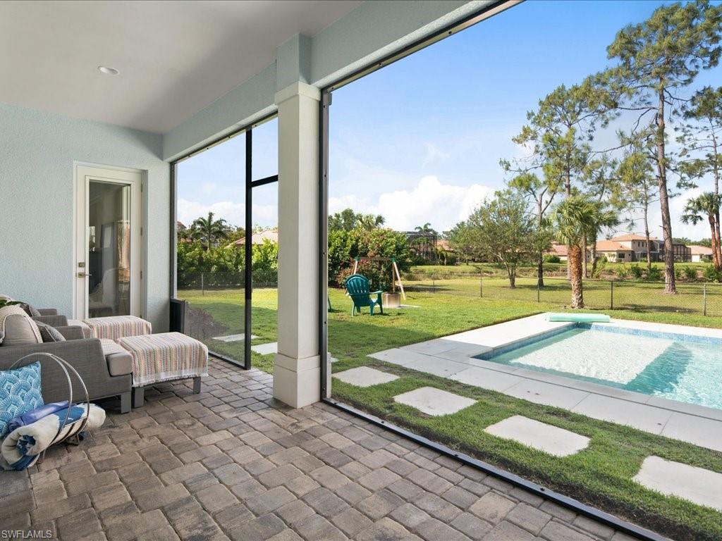 3275 68th Street Southwest Naples, FL 34105 - Photo 31 of 50 screened enclosure looking out towards yard