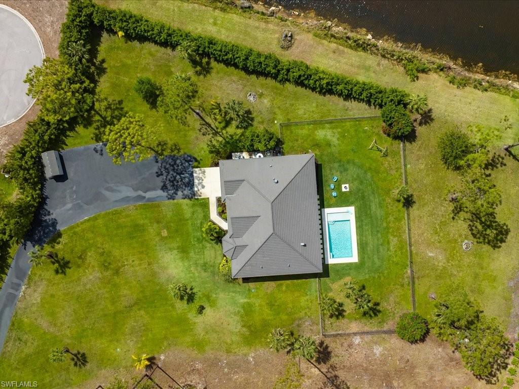 3275 68th Street Southwest Naples, FL 34105 - Photo 36 of 50 aerial of the pool, spacious side yards, and driveway