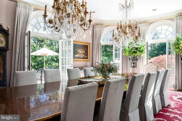a view of a dining room with furniture a chandelier and wooden floor