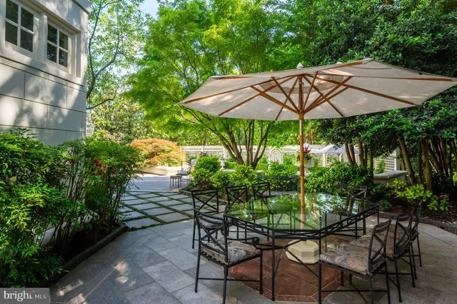 a patio with a patio table and chairs