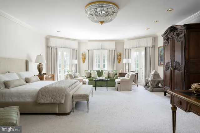 a bedroom with furniture and a large window