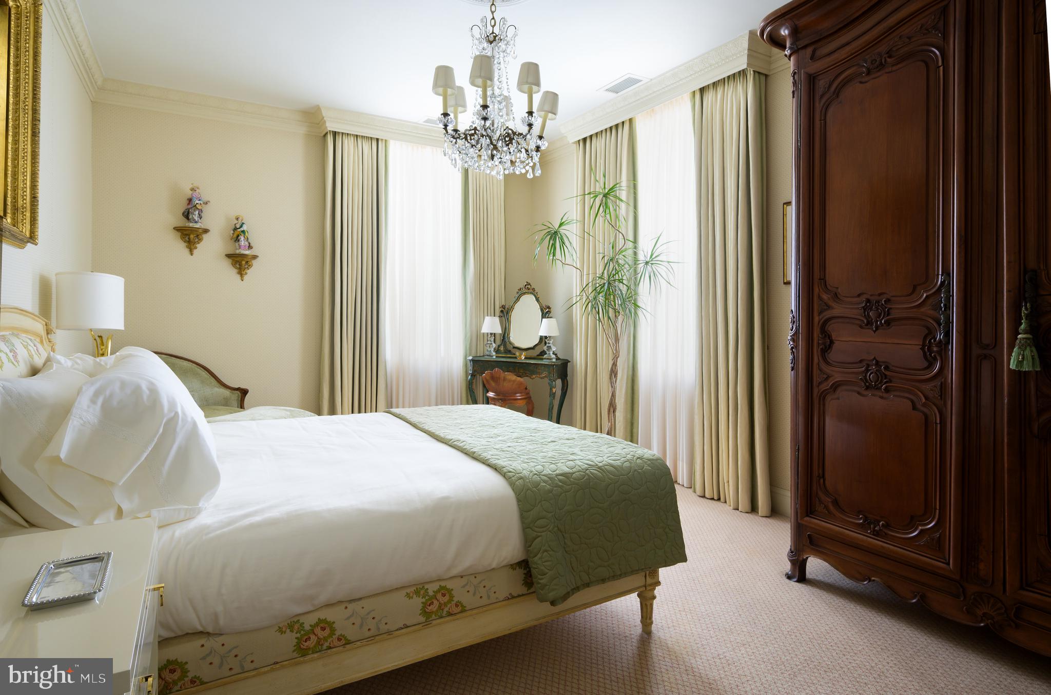 2838 McGill Terrace Northwest Washington, DC 20008 - Photo 39 of 50 a bedroom with a bed and a chandelier