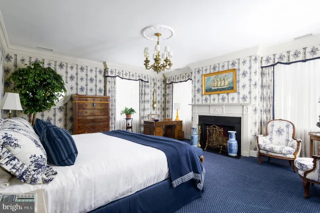 a bedroom with bed and a fireplace