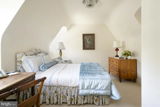 a bedroom with a bed and a table