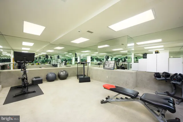 a room with gym equipment and view of living room