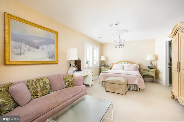 a spacious bedroom with a bed and a couch