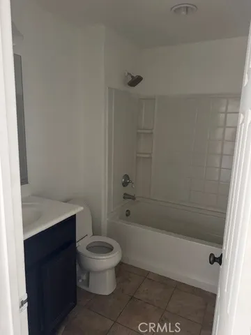 a white toilet sitting next to a bath tub