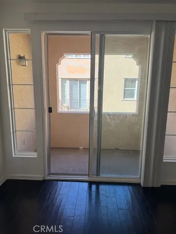 an empty room with wooden floor and a window
